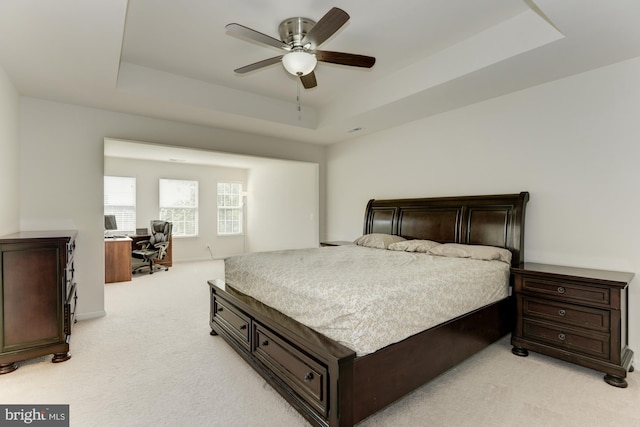 22672 Flowing Spring Sq, Brambleton, VA 20148 - bedroom featuring light carpet, a tray ceiling, a desk, and ceiling fan