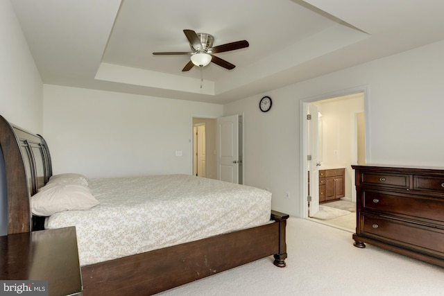 22672 Flowing Spring Sq, Brambleton, VA 20148 - bedroom with a tray ceiling, light carpet, ensuite bath, and ceiling fan