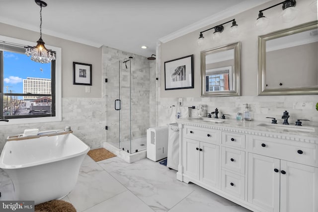 1001 S Chadwick St, Philadelphia, PA 19146 - full bathroom featuring a stall shower, plenty of natural light, tile walls, a freestanding tub, and double vanity