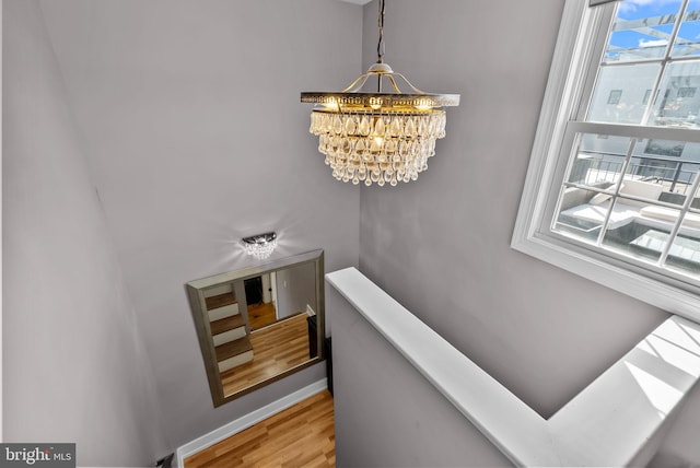 1001 S Chadwick St, Philadelphia, PA 19146 - stairs featuring a chandelier, plenty of natural light, wood finished floors, and baseboards