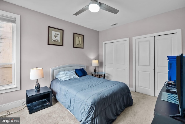 1001 S Chadwick St, Philadelphia, PA 19146 - carpeted bedroom featuring two closets, baseboards, and a ceiling fan