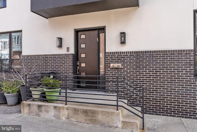 1001 S Chadwick St, Philadelphia, PA 19146 - doorway to property with stucco siding and brick siding