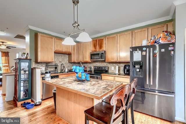 644 Luthardt Rd, Middle River, MD 21220 - kitchen featuring appliances with stainless steel finishes, a kitchen island, light wood-style flooring, decorative backsplash, and crown molding