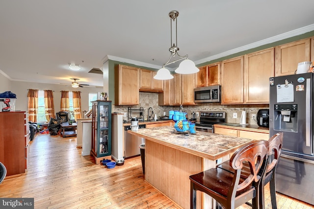 644 Luthardt Rd, Middle River, MD 21220 - kitchen featuring stainless steel appliances, backsplash, a kitchen island, crown molding, and light wood-style flooring