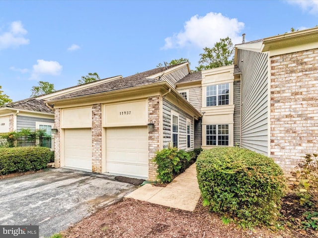 11937 Saint Francis Way, Bowie, MD 20721 - view of front of property featuring driveway, brick siding, and an attached garage