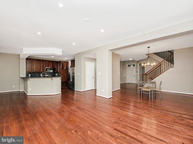 11937 Saint Francis Way, Bowie, MD 20721 - unfurnished living room with a chandelier, wood finished floors, baseboards, and recessed lighting