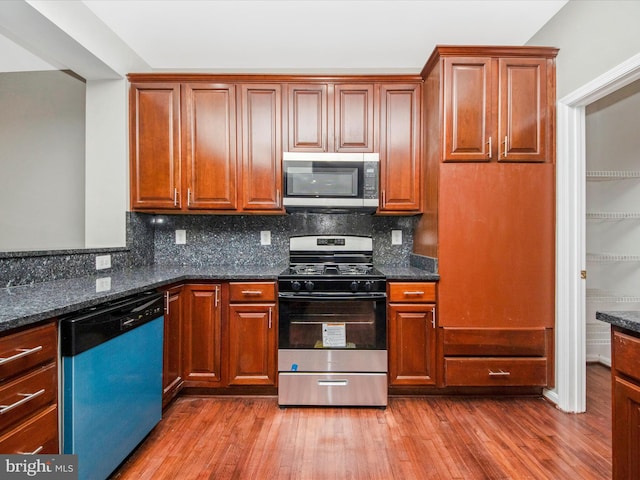 11937 Saint Francis Way, Bowie, MD 20721 - kitchen featuring stainless steel appliances, wood finished floors, and tasteful backsplash