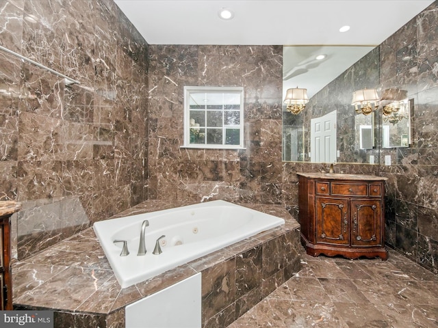 11937 Saint Francis Way, Bowie, MD 20721 - bathroom with marble tiled flooring, vanity, a tub with jets, recessed lighting, and tile walls