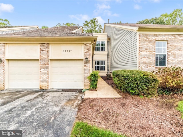 11937 Saint Francis Way, Bowie, MD 20721 - view of front of home featuring brick siding, asphalt driveway, and a garage