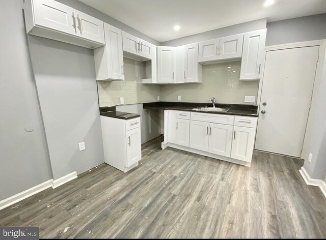 2922 W Norris St, Philadelphia, PA 19121 - kitchen featuring a sink, wood finished floors, backsplash, dark countertops, and recessed lighting