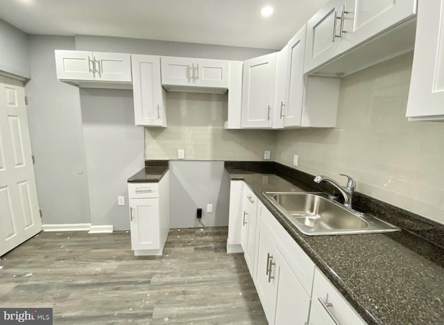 2922 W Norris St, Philadelphia, PA 19121 - kitchen with a sink, decorative backsplash, wood finished floors, white cabinetry, and recessed lighting