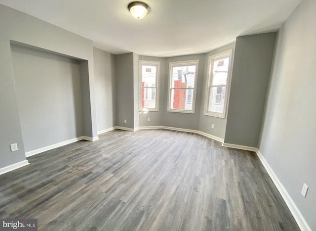 2922 W Norris St, Philadelphia, PA 19121 - unfurnished bedroom featuring dark wood-style flooring and baseboards