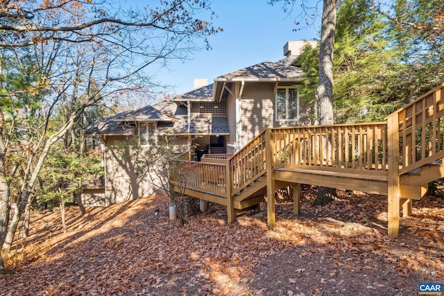 2028 Stone Rdg, Condos, Wintergreen Resort, VA 22967 - back of property with a chimney, a deck, and a shingled roof