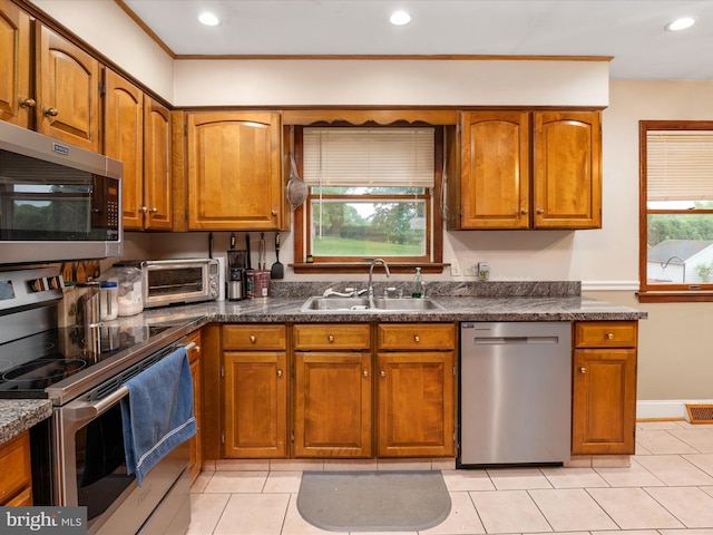 1112 Stromko Dr, Fallston, MD 21047 - kitchen with stainless steel appliances, a sink, brown cabinetry, dark countertops, and recessed lighting