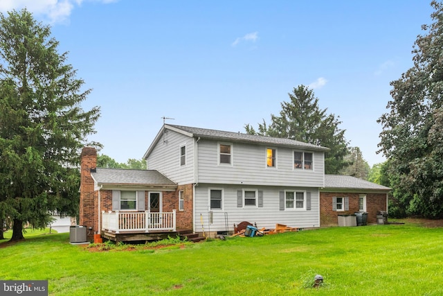 1112 Stromko Dr, Fallston, MD 21047 - back of house with a wooden deck, a chimney, a yard, brick siding, and central AC