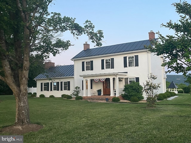 27986 Old Valley Pike, Toms Brook, VA 22660 - view of front of home featuring a standing seam roof, a chimney, metal roof, a front lawn, and stucco siding