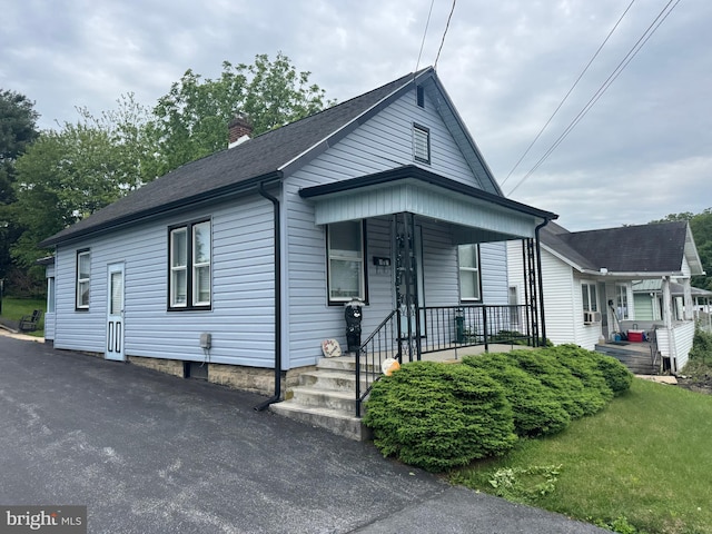 817 Maple St, Waynesboro, PA 17268 - view of front of house featuring covered porch, a chimney, and a shingled roof