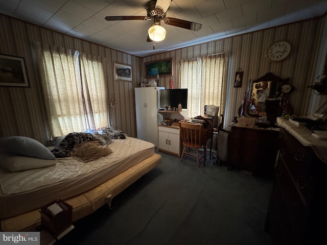 817 Maple St, Waynesboro, PA 17268 - carpeted bedroom with a ceiling fan and wood walls