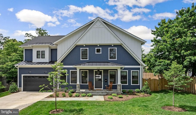 228 Manvell Rd SE, Vienna, VA 22180 - view of front of house with a standing seam roof, a porch, driveway, an attached garage, and metal roof