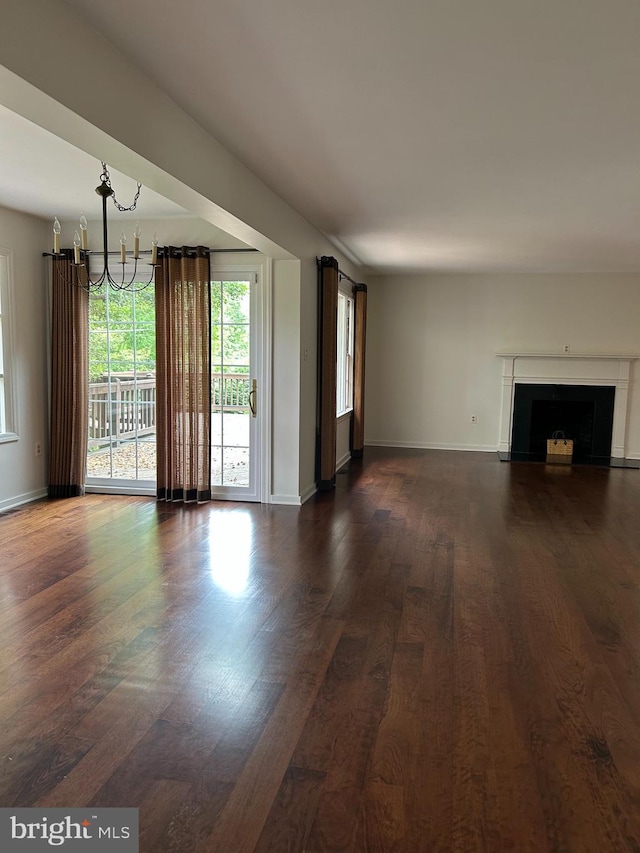 1821 Driver Ave, Lancaster, PA 17602 - unfurnished living room featuring a chandelier, dark wood-type flooring, baseboards, and a fireplace