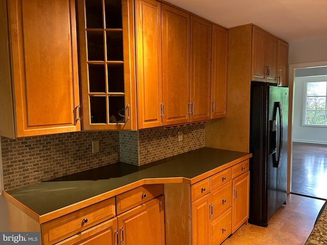 1821 Driver Ave, Lancaster, PA 17602 - kitchen featuring black fridge, backsplash, dark countertops, and brown cabinetry