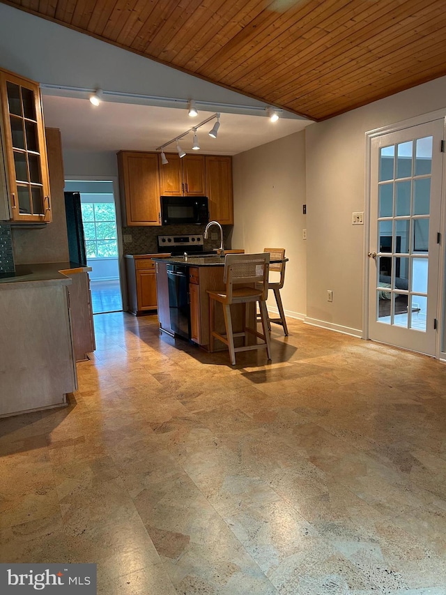 1821 Driver Ave, Lancaster, PA 17602 - kitchen with black appliances, wood ceiling, tasteful backsplash, brown cabinetry, and track lighting