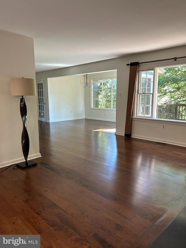1821 Driver Ave, Lancaster, PA 17602 - unfurnished living room featuring dark wood-type flooring, baseboards, and a chandelier