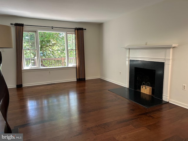 1821 Driver Ave, Lancaster, PA 17602 - unfurnished living room with wood finished floors, a fireplace with raised hearth, and baseboards