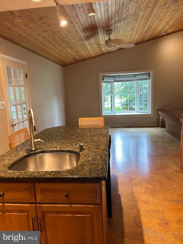 1821 Driver Ave, Lancaster, PA 17602 - kitchen with wood ceiling, a sink, dark stone countertops, and brown cabinetry