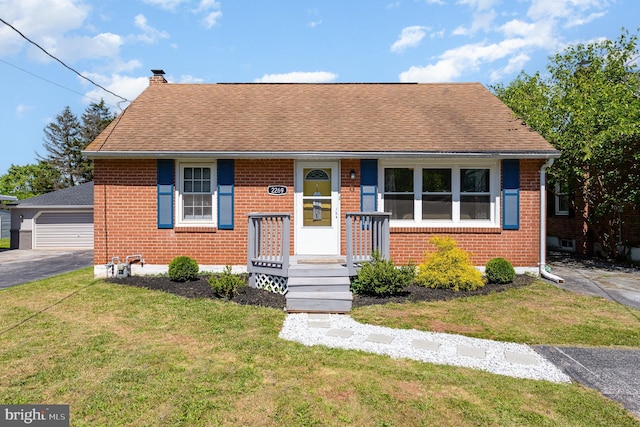 2269 Locust Ln, York, PA 17408 - view of front of property featuring brick siding, a chimney, a front lawn, a garage, and a shingled roof