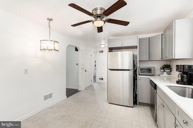 2269 Locust Ln, York, PA 17408 - kitchen with appliances with stainless steel finishes, gray cabinets, light countertops, arched walkways, and a ceiling fan