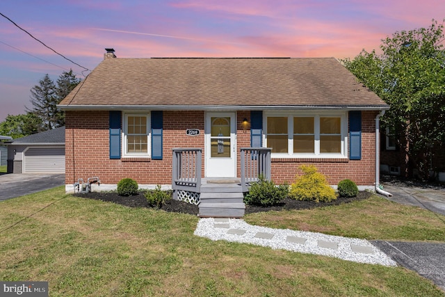 2269 Locust Ln, York, PA 17408 - bungalow-style house with brick siding, a chimney, a front lawn, and a detached garage