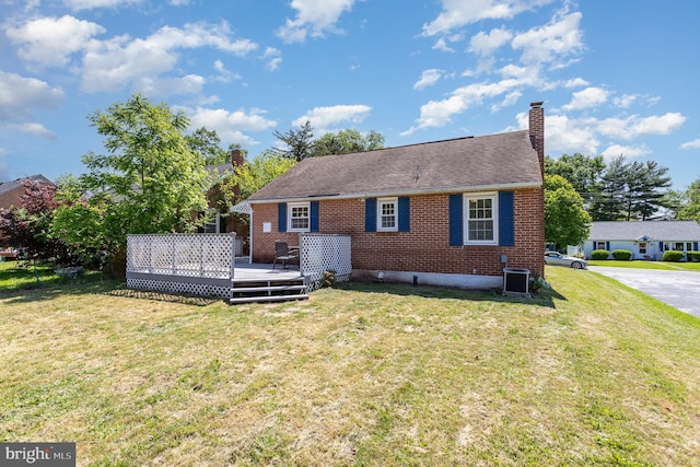 2269 Locust Ln, York, PA 17408 - back of property featuring brick siding, a chimney, a yard, a deck, and cooling unit