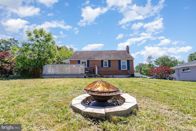 2269 Locust Ln, York, PA 17408 - back of property with a fire pit, brick siding, a chimney, and a lawn