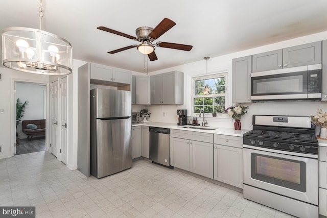 2269 Locust Ln, York, PA 17408 - kitchen with appliances with stainless steel finishes, a sink, gray cabinetry, light countertops, and a ceiling fan
