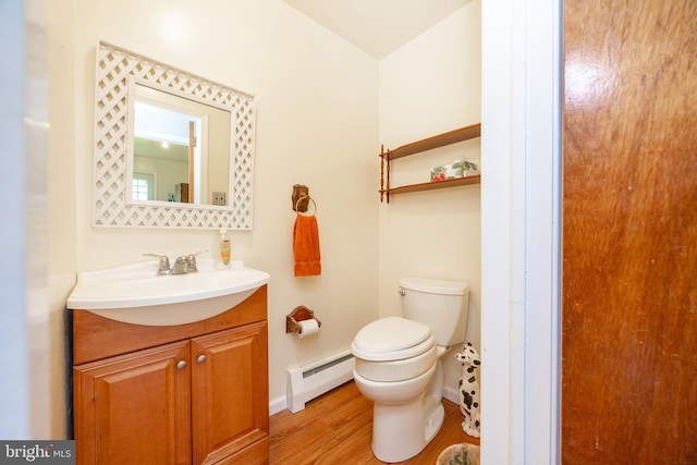 306 Spring Cir, Norristown, PA 19403 - half bath with a baseboard heating unit, toilet, wood finished floors, and baseboards