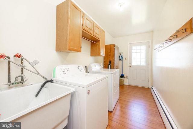 306 Spring Cir, Norristown, PA 19403 - laundry room with baseboard heating, washer and dryer, light wood finished floors, cabinet space, and baseboards