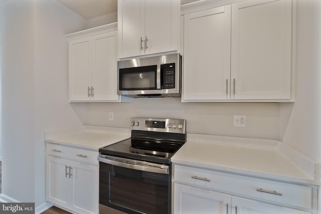 488 National St, Ranson, WV 25438 - kitchen with appliances with stainless steel finishes, white cabinets, and light stone counters