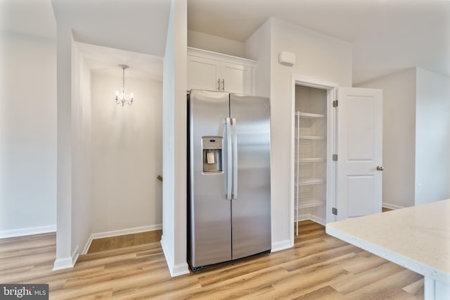 488 National St, Ranson, WV 25438 - kitchen featuring stainless steel refrigerator with ice dispenser, light wood finished floors, white cabinetry, and light stone countertops