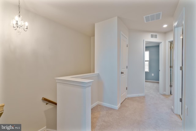 488 National St, Ranson, WV 25438 - hallway with an upstairs landing, light carpet, baseboards, and a chandelier