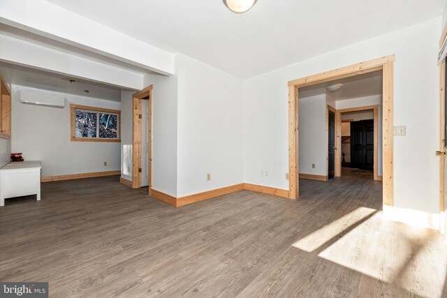 12814 Appel Rd SE, Little Orleans, MD 21766 - spare room with an AC wall unit, wood finished floors, and baseboards