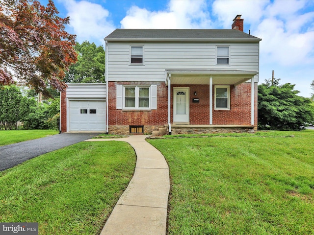 1411 College Ave, Reading, PA 19604 - view of front facade featuring an attached garage, a chimney, driveway, brick siding, and a front yard