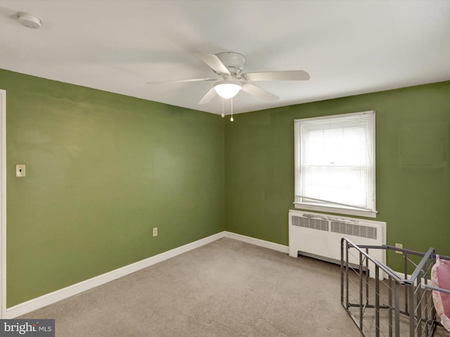 1411 College Ave, Reading, PA 19604 - carpeted empty room with radiator, a smoke detector, baseboards, and a ceiling fan