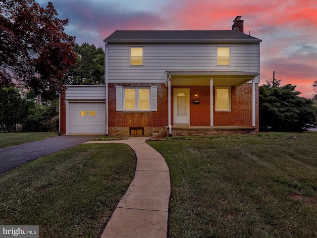 1411 College Ave, Reading, PA 19604 - traditional-style home featuring an attached garage, a chimney, a front lawn, brick siding, and driveway