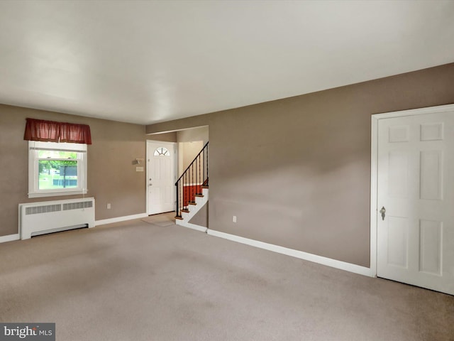 1411 College Ave, Reading, PA 19604 - unfurnished living room with radiator, baseboards, carpet floors, and stairway