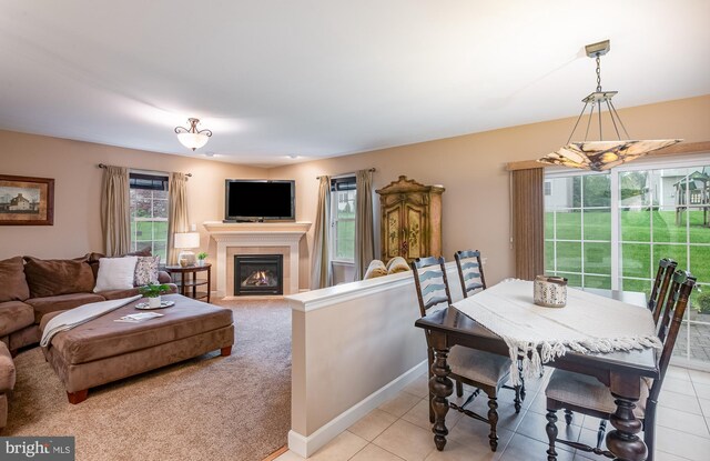 310 Valley Ct, Reading, PA 19608 - dining area featuring a tile fireplace, light tile patterned floors, and baseboards