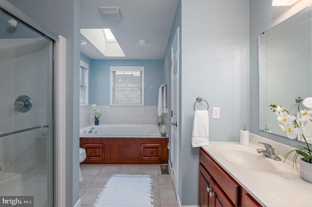310 Valley Ct, Reading, PA 19608 - full bath with vanity, toilet, a skylight, tile patterned flooring, and a shower stall