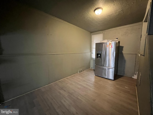 2074 E Clementine St, Philadelphia, PA 19134 - kitchen with stainless steel refrigerator with ice dispenser, wood finished floors, and a textured ceiling