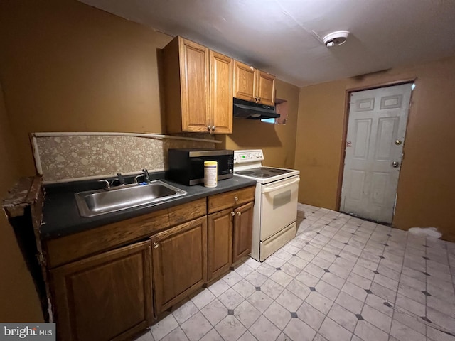 2074 E Clementine St, Philadelphia, PA 19134 - kitchen featuring white electric stove, stainless steel microwave, a sink, under cabinet range hood, and dark countertops