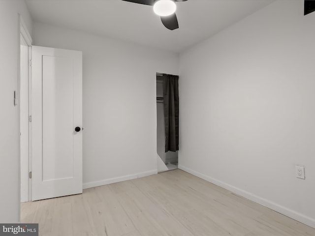 2002 E Preston St, Baltimore, MD 21213 - unfurnished bedroom featuring wood finished floors, baseboards, and a ceiling fan